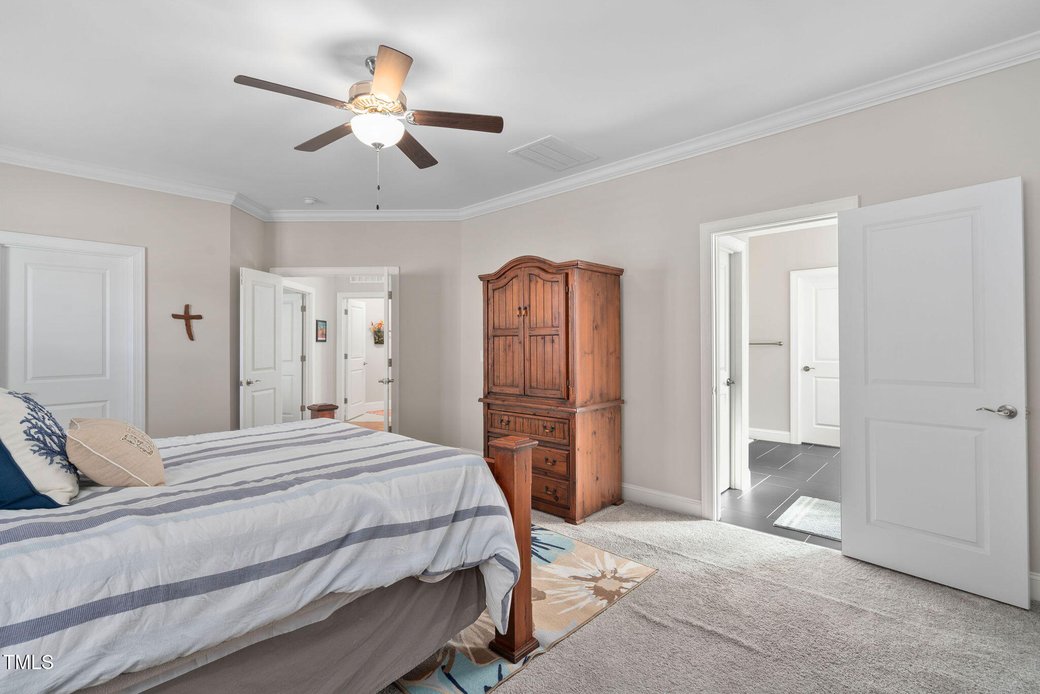 2461 Stonehenge Park Drive Raleigh, NC 27613 - Photo 25 of 72 a bedroom with a bed and a chandelier
