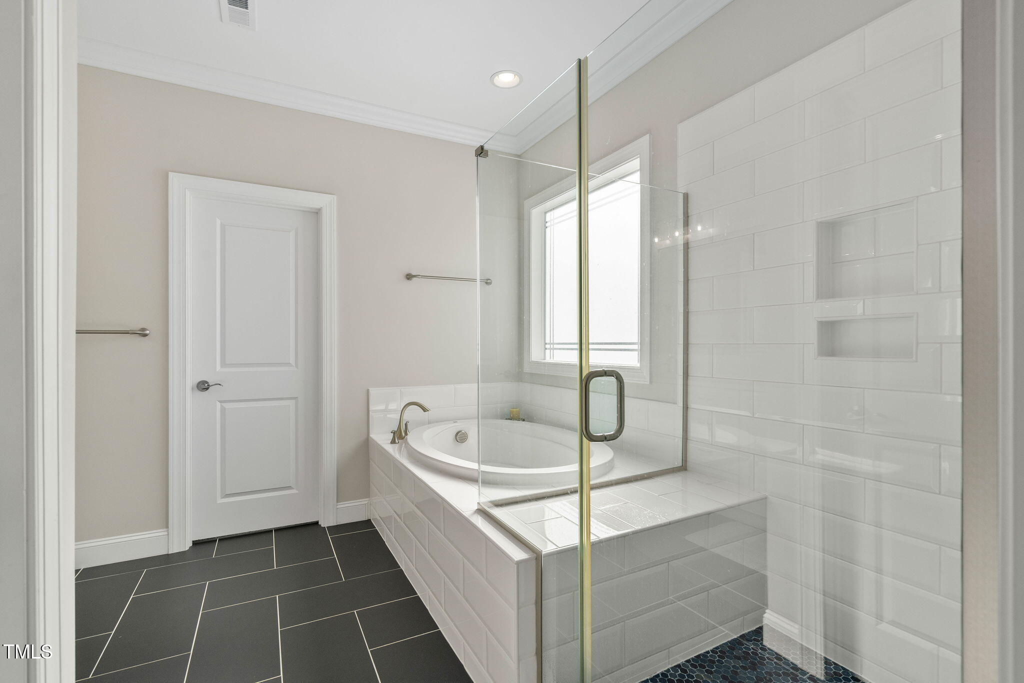 2461 Stonehenge Park Drive Raleigh, NC 27613 - Photo 28 of 72 a bathroom with a sink a mirror and a bathtub