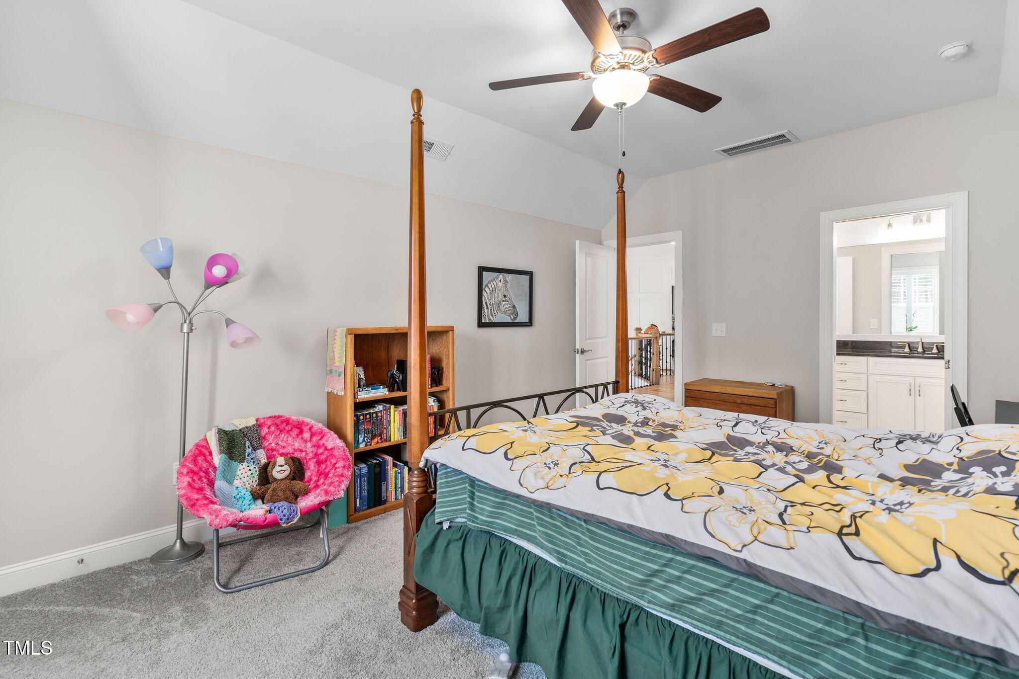 2461 Stonehenge Park Drive Raleigh, NC 27613 - Photo 32 of 72 a bedroom with a bed and a chandelier