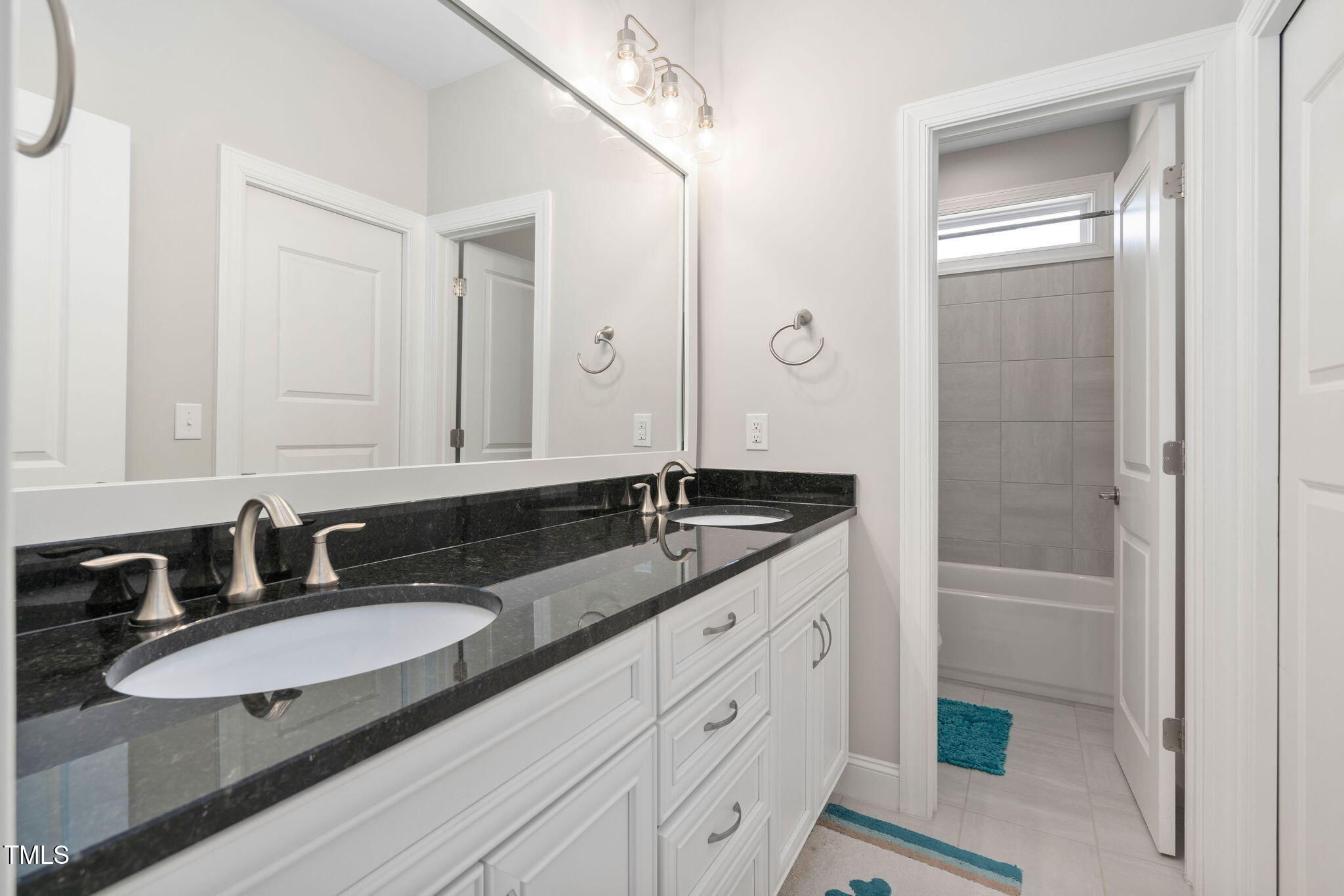 2461 Stonehenge Park Drive Raleigh, NC 27613 - Photo 34 of 72 a bathroom with a granite countertop sink and a mirror