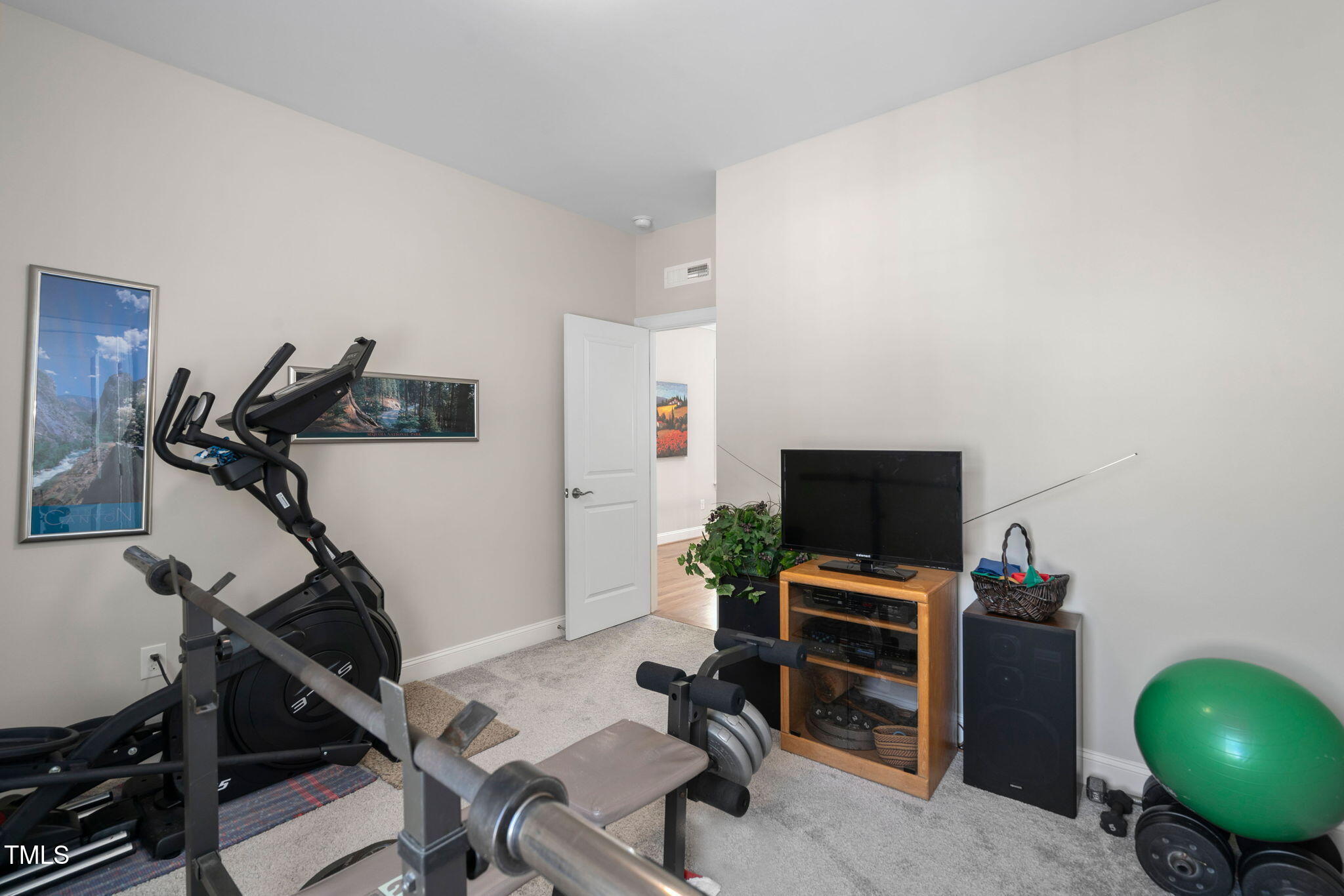 2461 Stonehenge Park Drive Raleigh, NC 27613 - Photo 39 of 72 a view of a workspace with furniture and a gym cycle