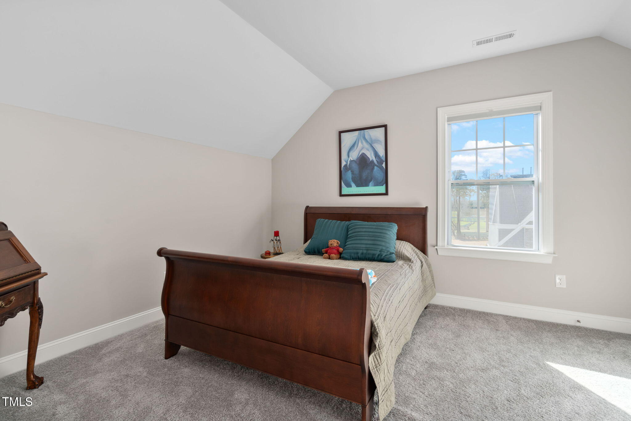 2461 Stonehenge Park Drive Raleigh, NC 27613 - Photo 41 of 72 a bed sitting in a bedroom next to a window