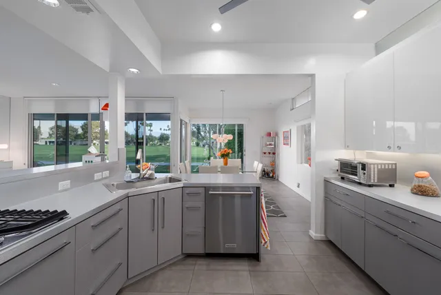a kitchen with stove a sink and cabinets