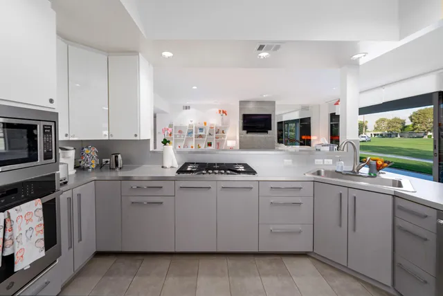 a kitchen with a sink stove and cabinets