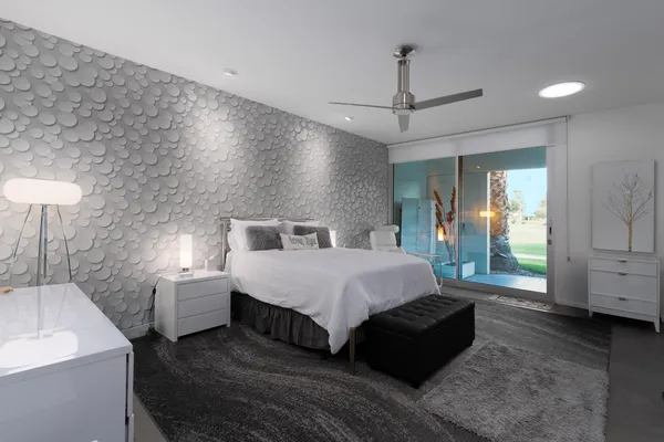 a spacious bedroom with a bed a rug and a walk in closet