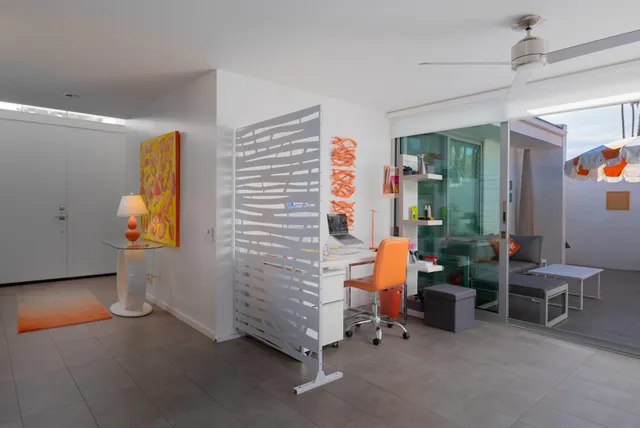 a view of an empty room with workspace and windows