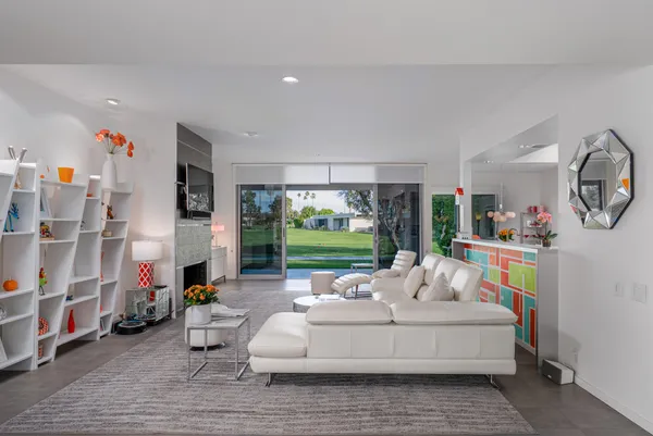 a living room with furniture and a floor to ceiling window