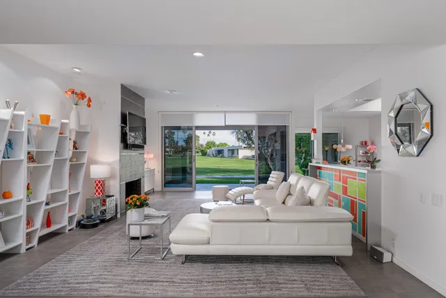 a living room with furniture and a floor to ceiling window