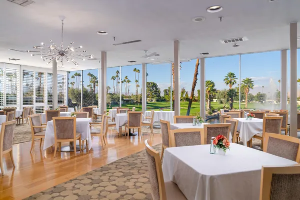 a view of a dining room with furniture large windows and wooden floor