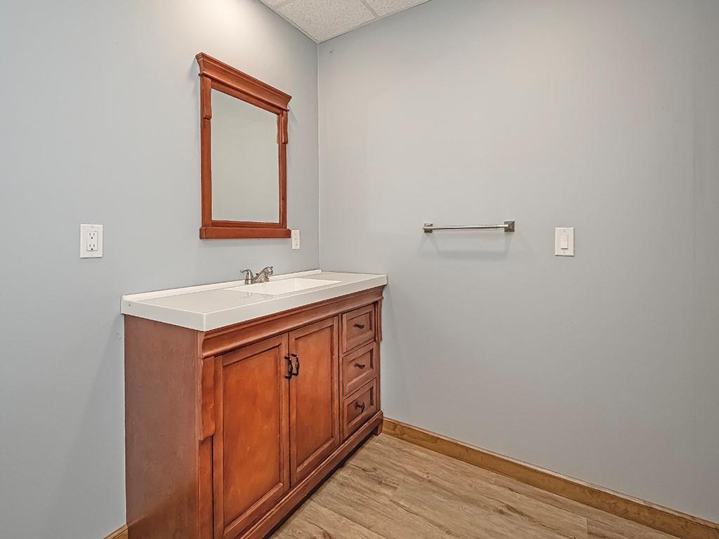 247 Rader School Road Renfrew, PA 16053 - Photo 11 of 28 a utility room with a sink a mirror and wooden floor