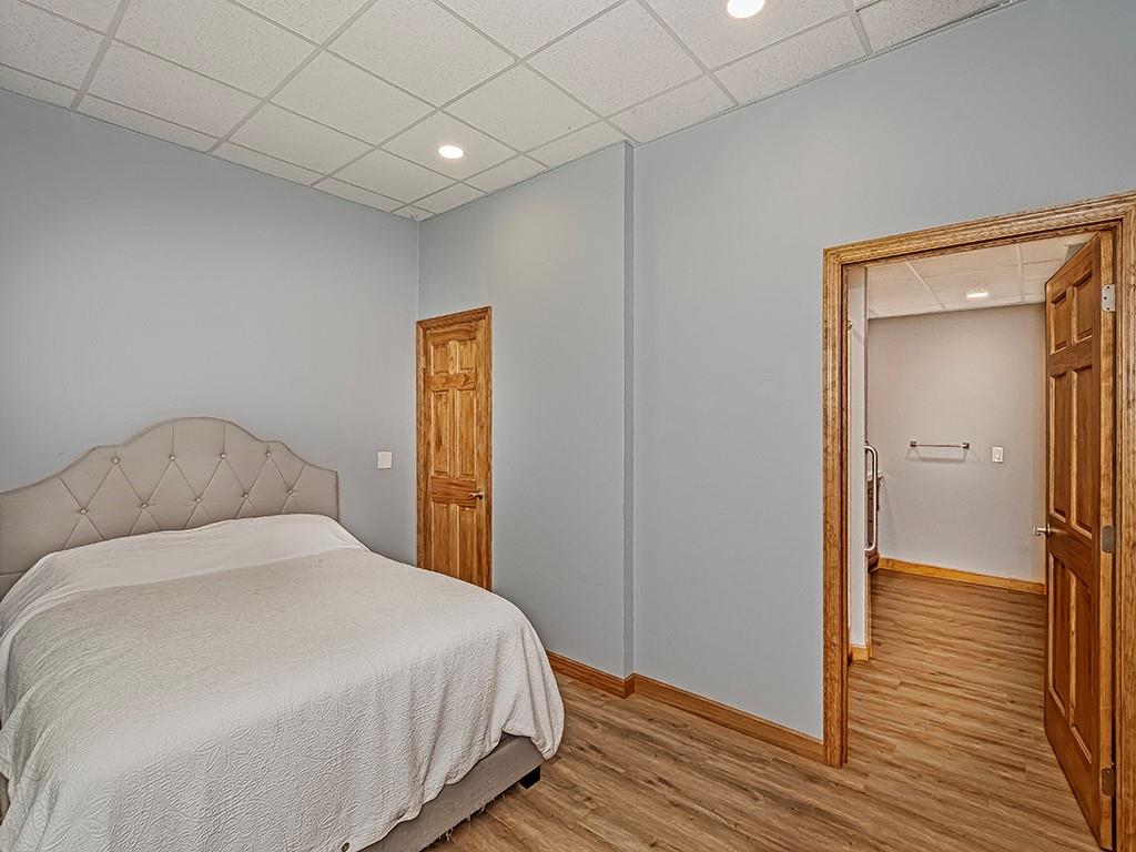 247 Rader School Road Renfrew, PA 16053 - Photo 14 of 28 a bedroom with a bed and wooden floor