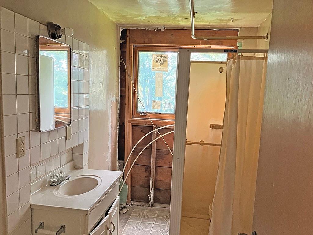 247 Rader School Road Renfrew, PA 16053 - Photo 23 of 28 a bathroom with a sink vanity granite tub and shower