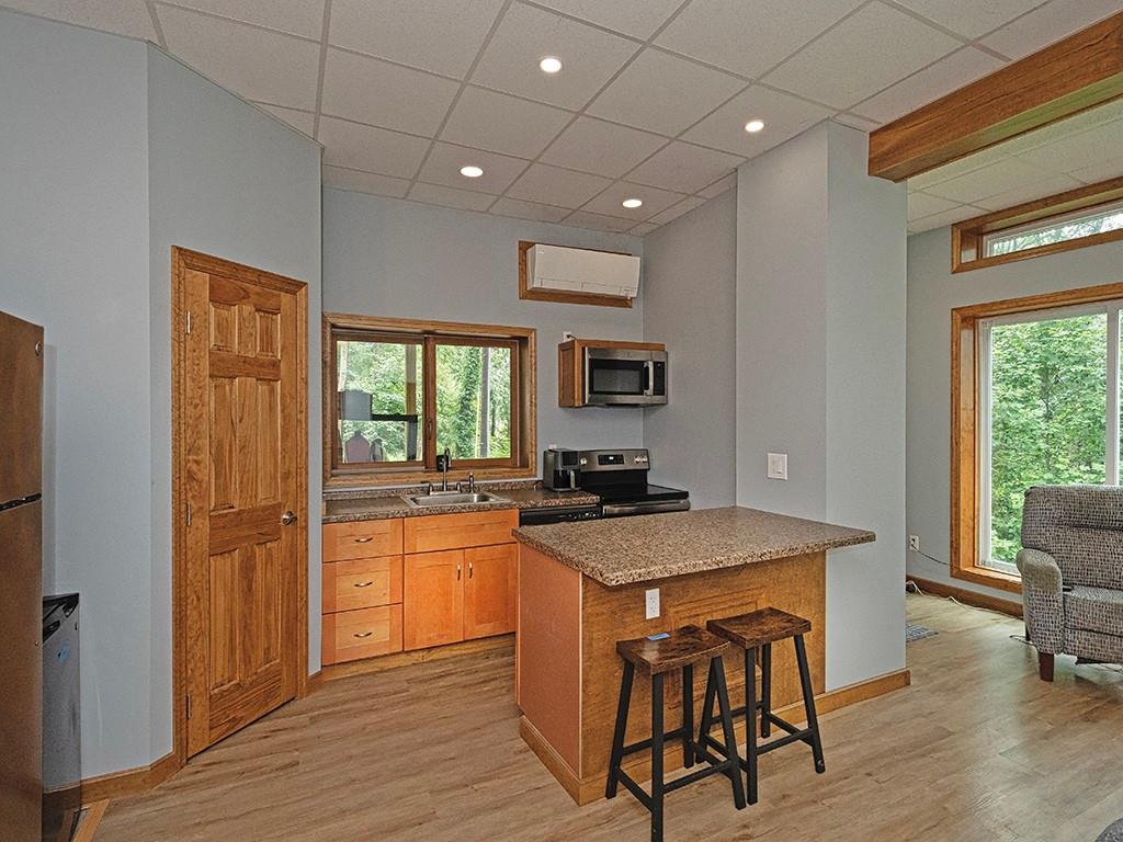 247 Rader School Road Renfrew, PA 16053 - Photo 7 of 28 a kitchen with a stove a sink and a refrigerator