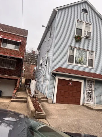 a front view of a house with garage