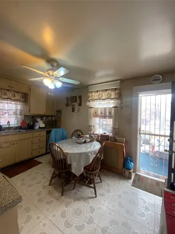 a view of a dining room with furniture and window