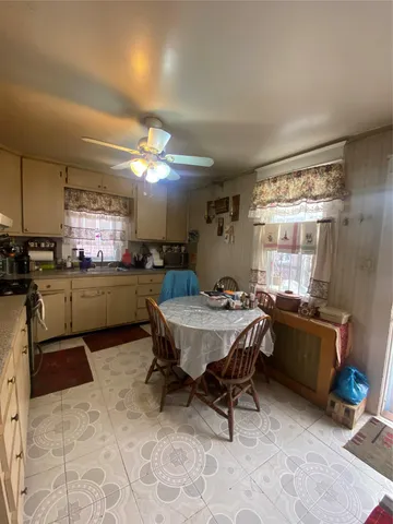 a kitchen with a table and chairs in it