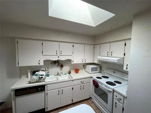 a kitchen with a sink stove and cabinets