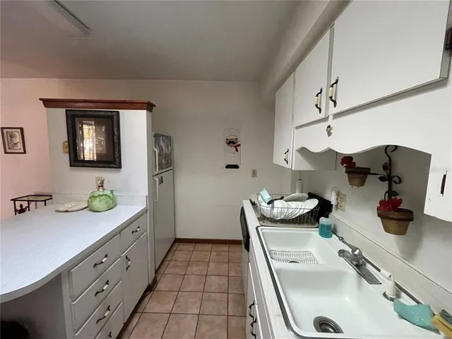 a kitchen with stainless steel appliances kitchen island granite countertop a sink and cabinets