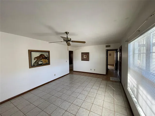 a view of a livingroom with an empty space and a window