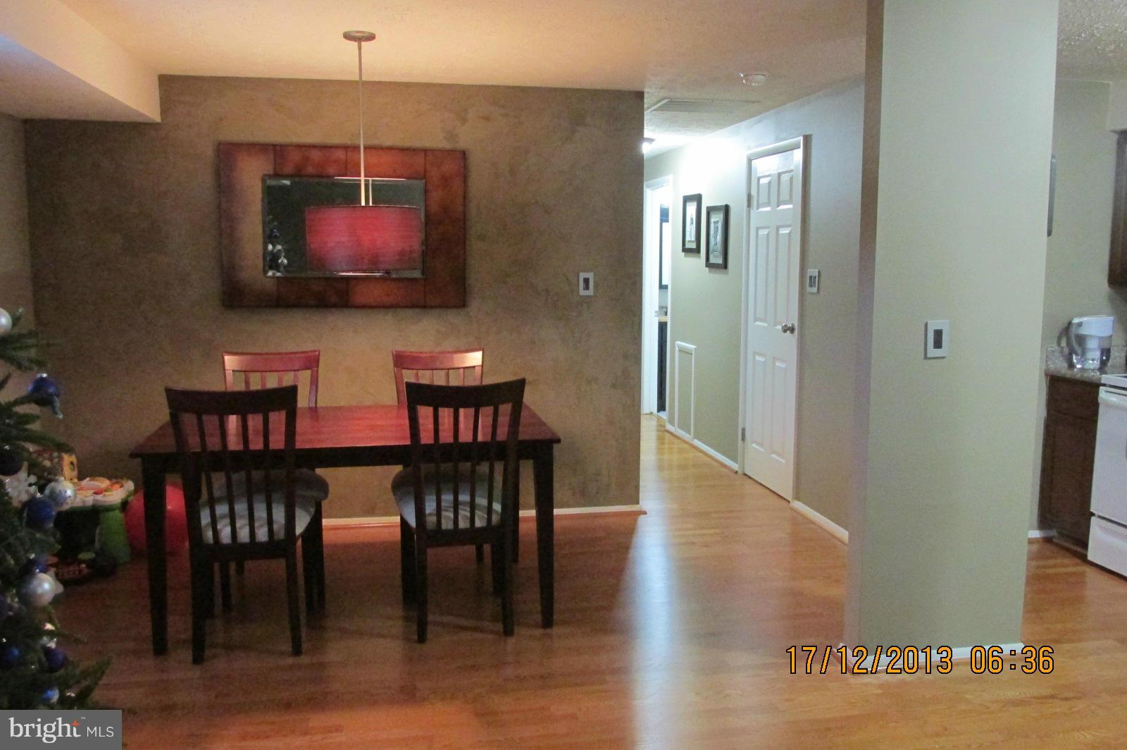 12405 Hickory Tree Way, Unit 613 Germantown, MD 20874 - Photo 4 of 9 a dining room with furniture and wooden floor