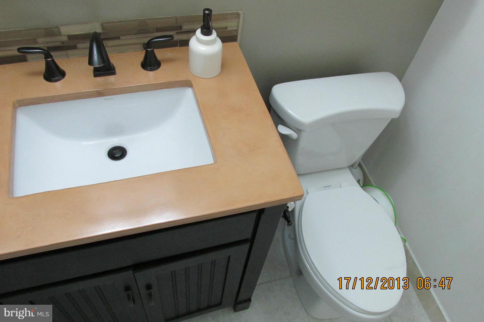 12405 Hickory Tree Way, Unit 613 Germantown, MD 20874 - Photo 9 of 9 a bathroom with a toilet and a sink