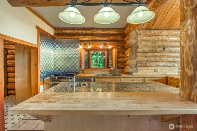 a view of a swimming pool with a dining table and chairs