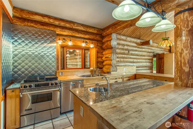 a kitchen with stainless steel appliances granite countertop a sink and cabinets