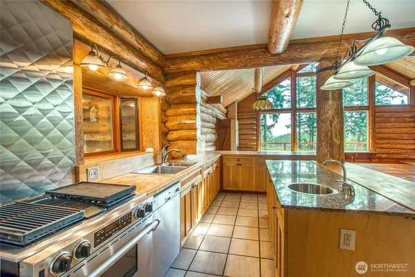 a large kitchen with a stove and a large window