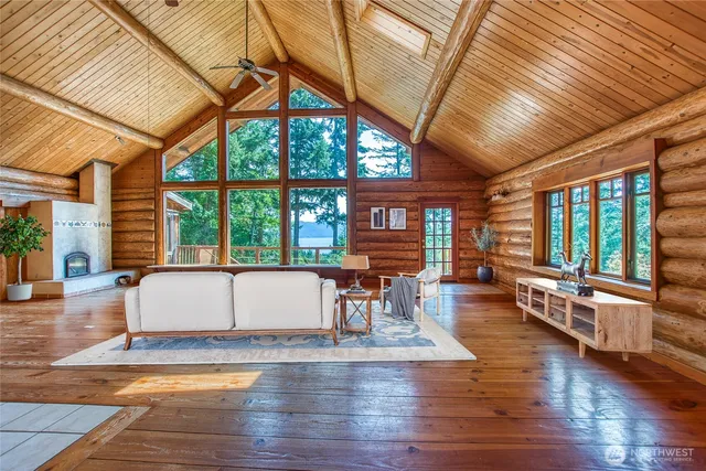 a view of living room with furniture and large windows