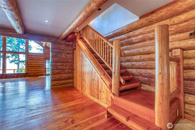 a view of entryway and hall with wooden floor