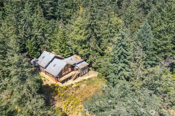 an aerial view of a house with a yard