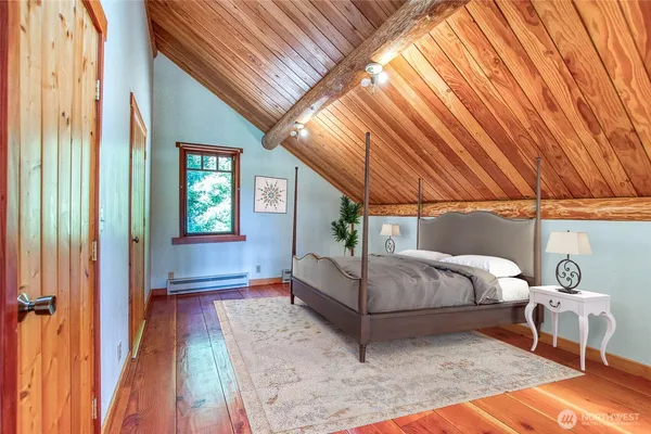 a bedroom with a bed and a table