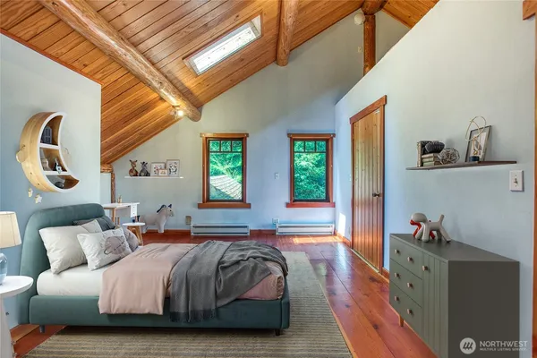 a spacious bedroom with a bed and window