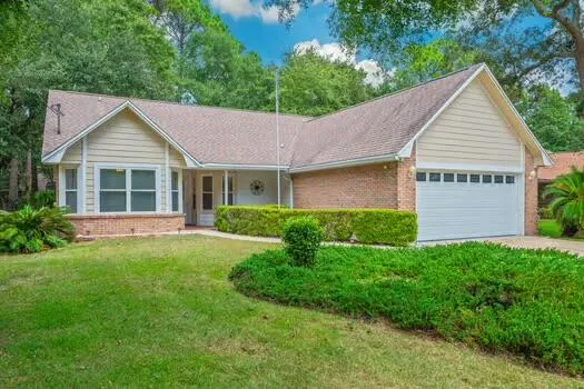 a view of a house with a yard and potted plants
