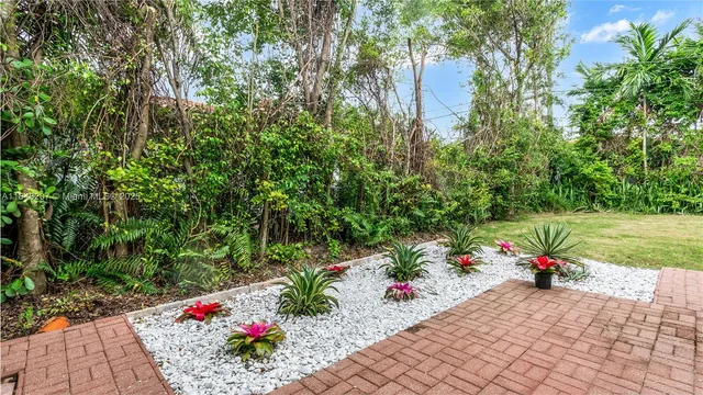 a park view with potted plants and large trees