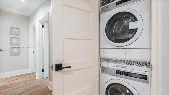 a view of a hallway with washer and dryer