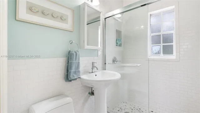 a bathroom with a sink toilet and shower