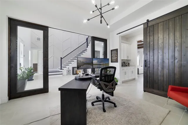 a living room with furniture a flat screen tv and kitchen view