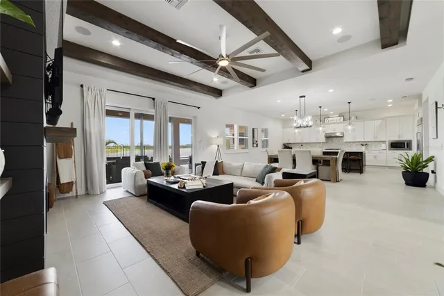 a large kitchen with stainless steel appliances granite countertop a sink a stove and a refrigerator