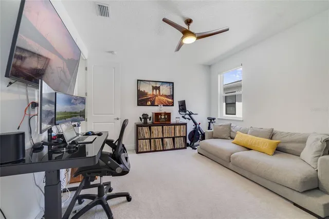 a bedroom with a bed and ceiling fan