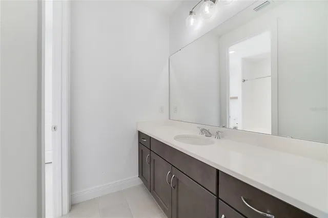 a bathroom with a sink toilet vanity and bathtub