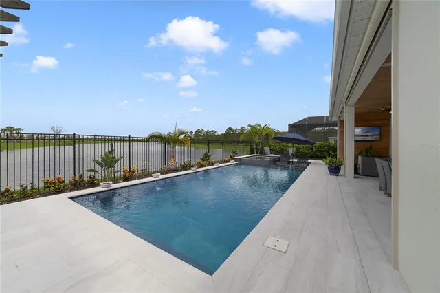 a living room with couches a flat screen tv and outdoor view