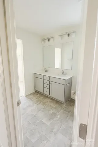 a view of a kitchen with white cabinets