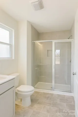 a bathroom with a shower a toilet and a sink