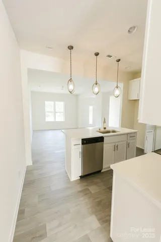 a large kitchen with kitchen island a stove a sink a center island and windows