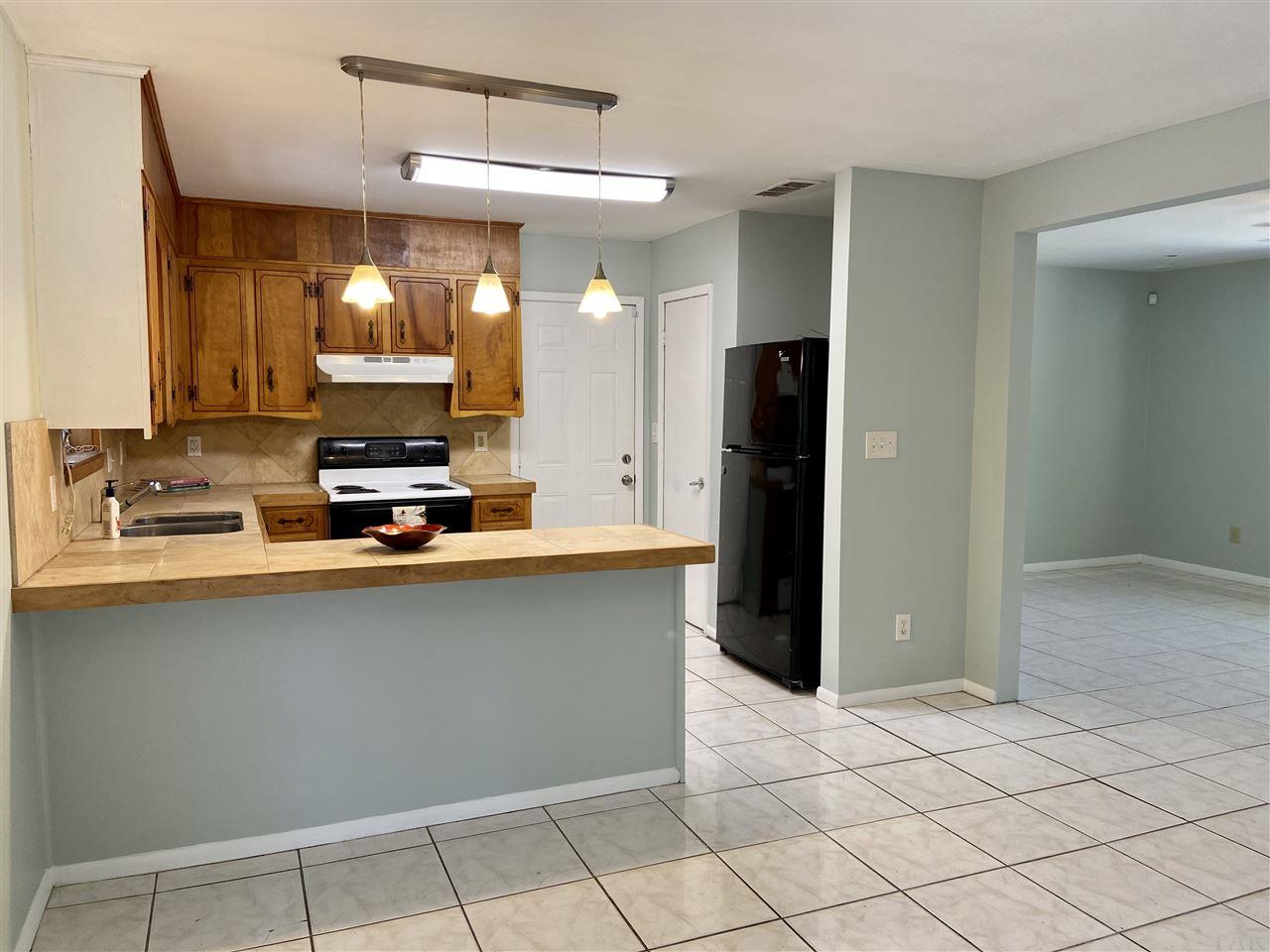 4861 Creighton Road Pensacola, FL 32504 - Photo 11 of 50 Door right of Stove goes to Garage
