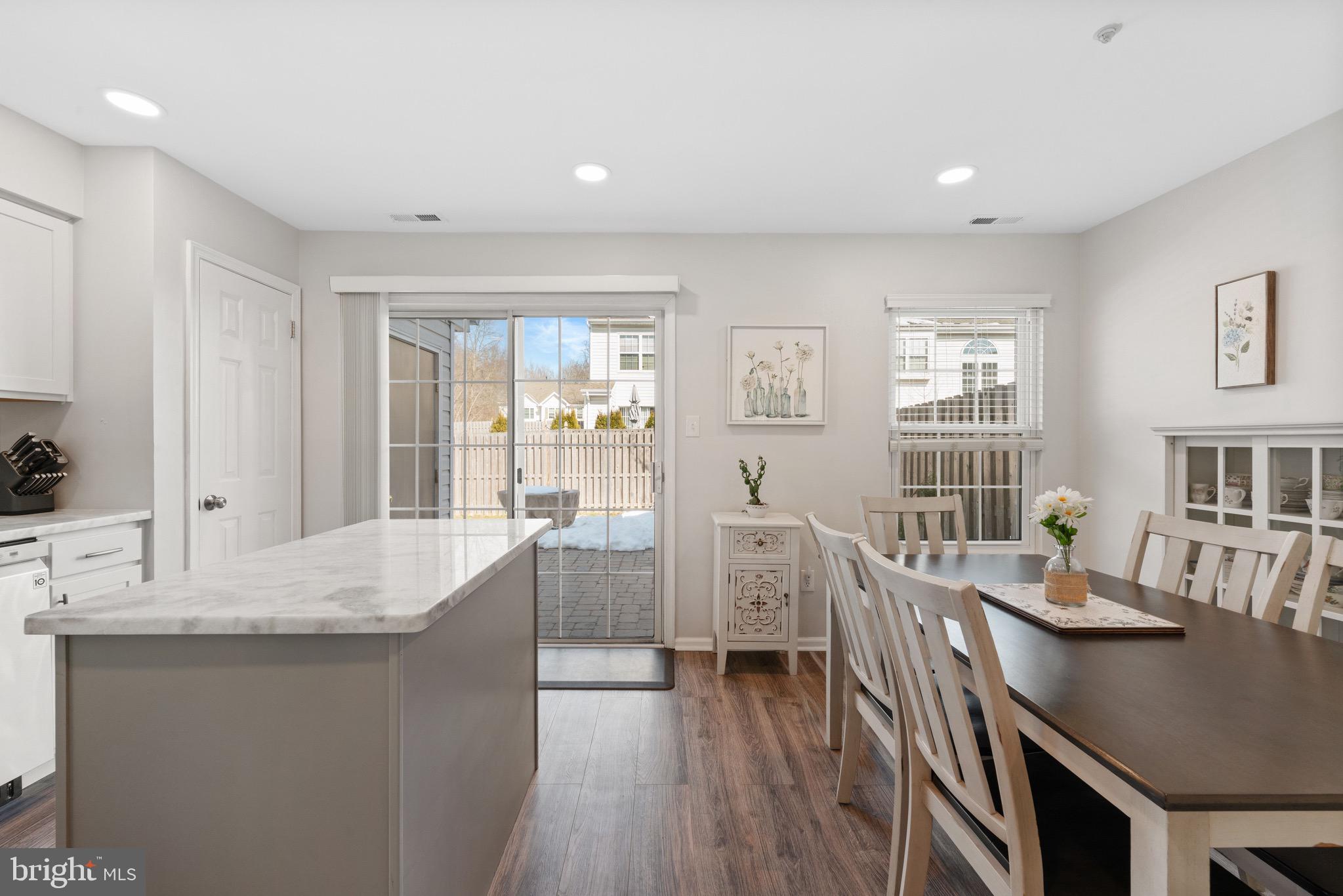 135 Buckingham Way Mount Laurel, NJ 08054 - Photo 11 of 30 a large living room with stainless steel appliances granite countertop a stove a sink a dining table and chairs