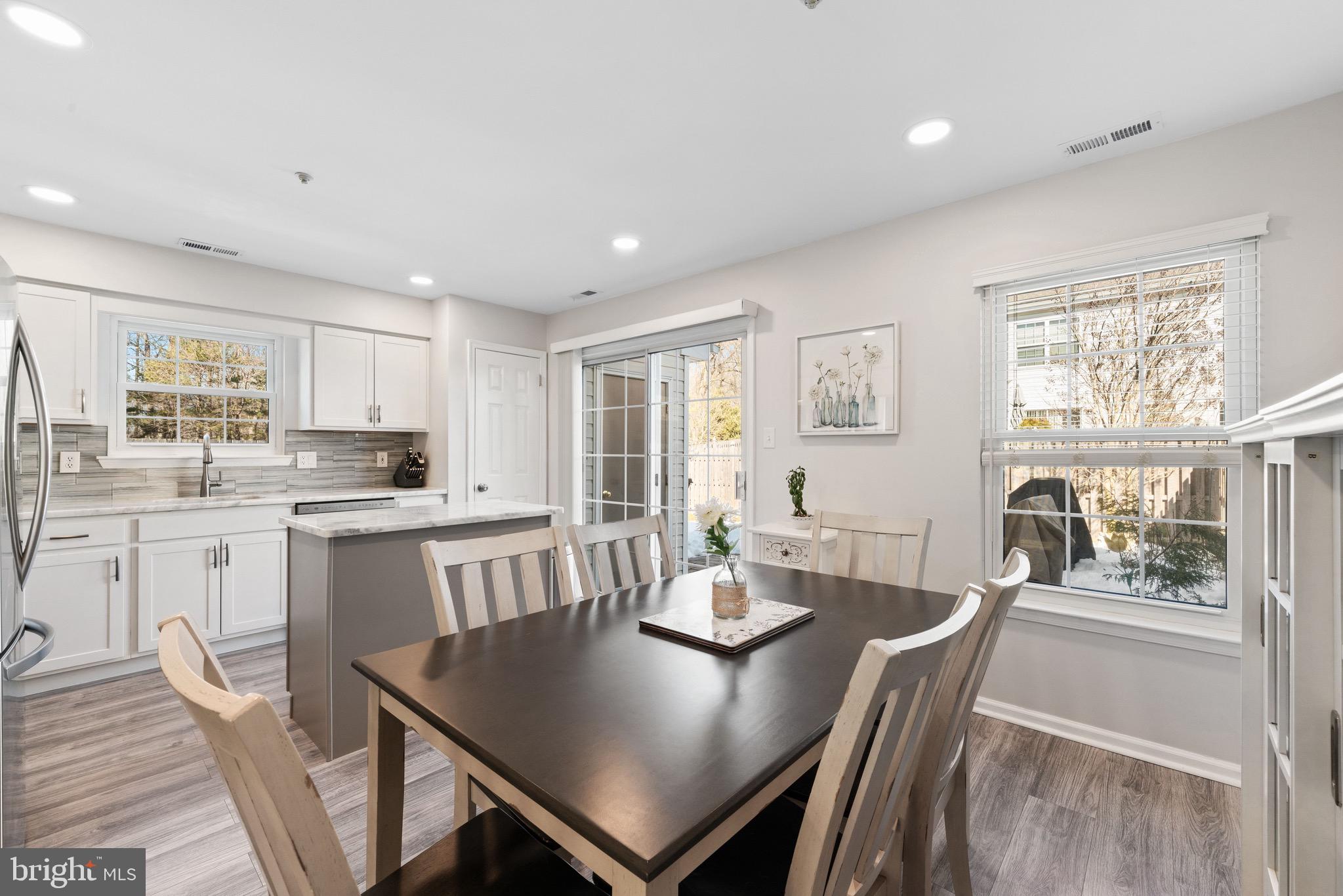 135 Buckingham Way Mount Laurel, NJ 08054 - Photo 12 of 30 a open dining room with stainless steel appliances granite countertop a table chairs and a refrigerator