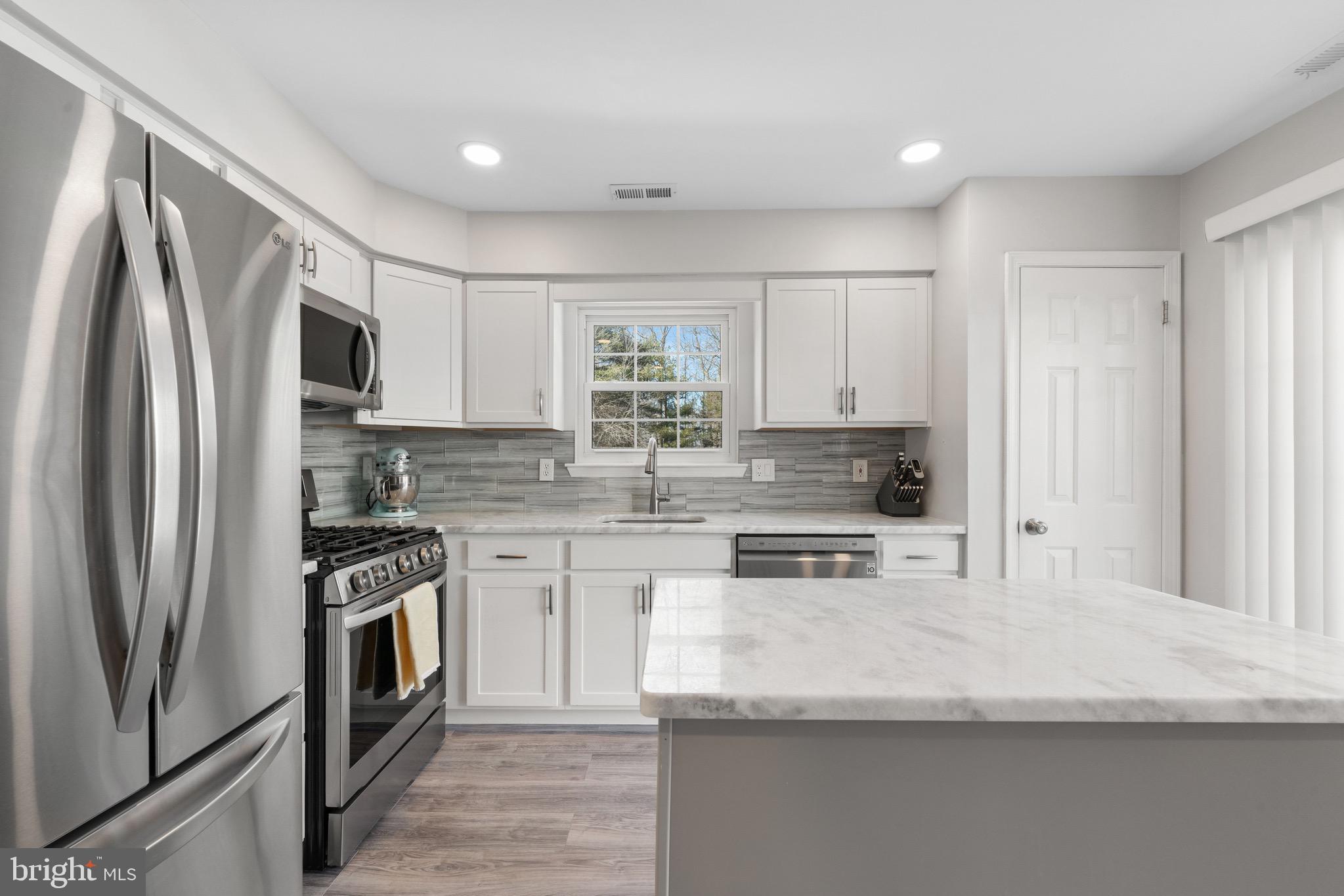 135 Buckingham Way Mount Laurel, NJ 08054 - Photo 13 of 30 a kitchen with stainless steel appliances granite countertop a refrigerator sink and stove