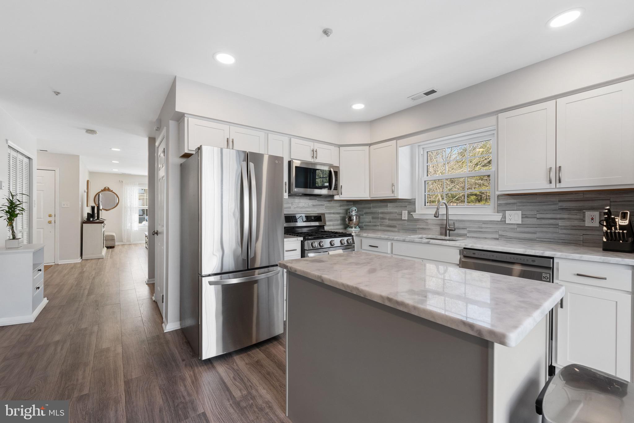 135 Buckingham Way Mount Laurel, NJ 08054 - Photo 14 of 30 a kitchen with stainless steel appliances granite countertop a refrigerator microwave and stove